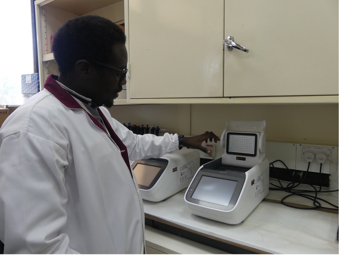 John Juma demonstrating how the molecular technique works to amplify RVFV (photo credit: ILRI/Kristina Roesel).