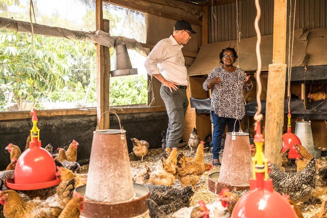 Suzman and Theuri visit her chicken coop at home. Photo BMGF