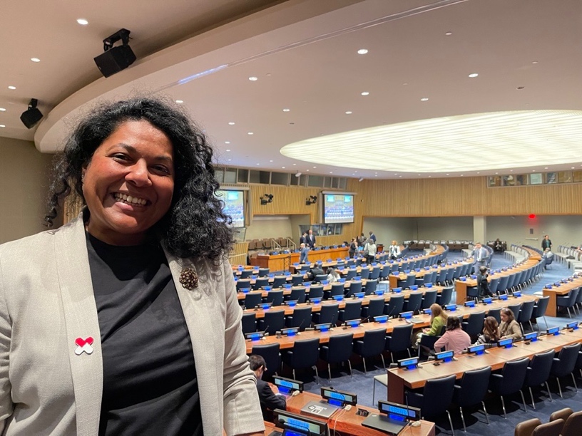 A person standing in a room with rows of chairs</p>
<p>AI-generated content may be incorrect.