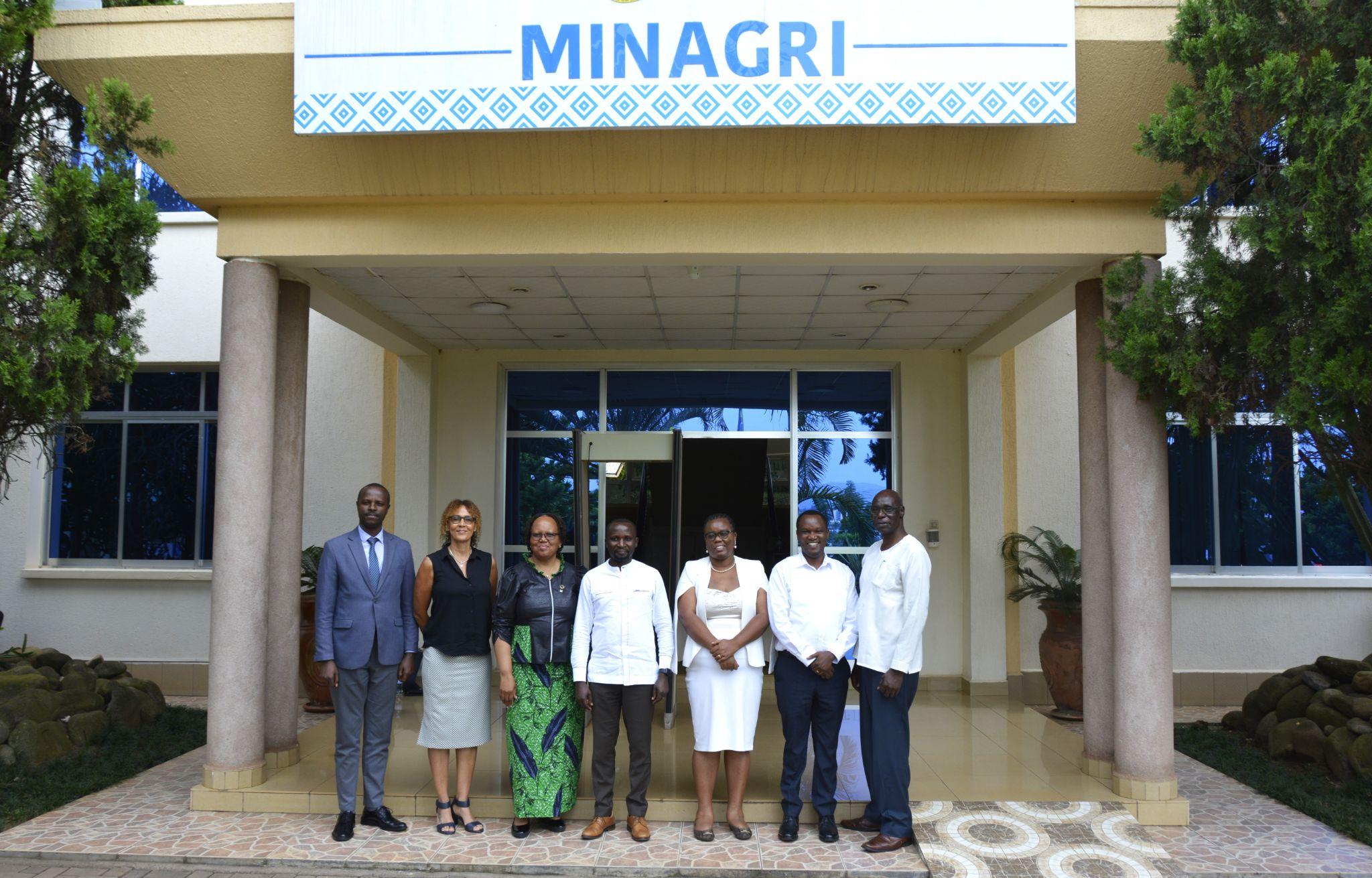 A group of people standing in front of a building</p>
<p>Description automatically generated