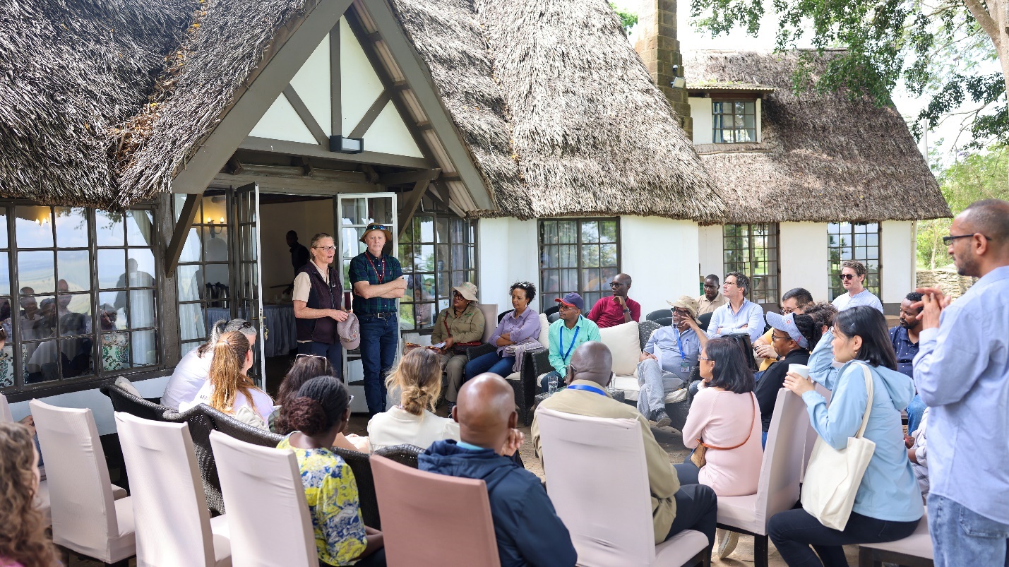 A group of people sitting outside a house</p>
<p>AI-generated content may be incorrect.