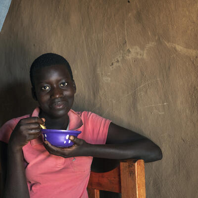 A Kenyan woman eats a meal