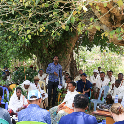 A community meeting in a field