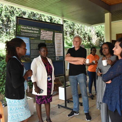 Esther Omosa, ILRI nutritionist, explaining about nutrition research at ILRI to Holger Meinke, ISDC Chair and Fetien Abera, ISDC member (ILRI/Kristen Tam). 