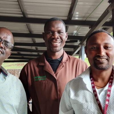 PhD students Demissie Dawana (left) and Tegegn Fantahun (far right) from the Mazingira Centre spent time with Loyapin Bondé (center) to demonstrate and explain how the biodigester is an effective tool to reduce manure emissions and transform manure into fertilizer. Photo courtesy of Loyapin Bondé