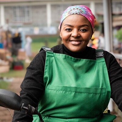 Agripreneur Mwende Baraka, played by Fiona Ashley, defies expectations of women in her community by riding her motorbike through Makutano, delivering veterinary services, vaccinated chicks, and farm inputs to her women clients in the new edutainment series, “Maisha Makutano” (photo credit: Mia Collins). Agripreneur Mwende Baraka, played by Fiona Ashley, defies expectations of women in her community by riding her motorbike through Makutano, delivering veterinary services, vaccinated chicks, and farm inputs to her women clients in the new edutainment series, “Maisha Makutano” (photo credit: Mia Collins).