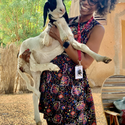 Pacem holds a goat