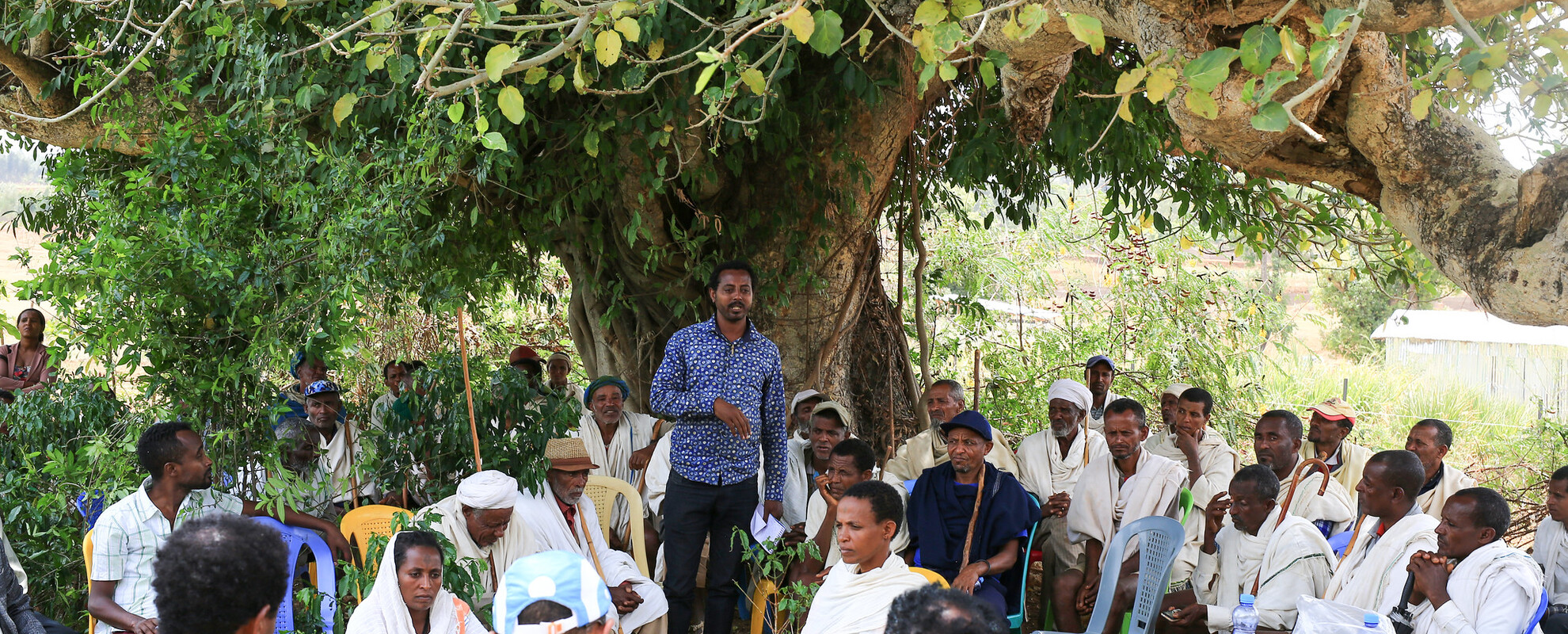 A community meeting in a field