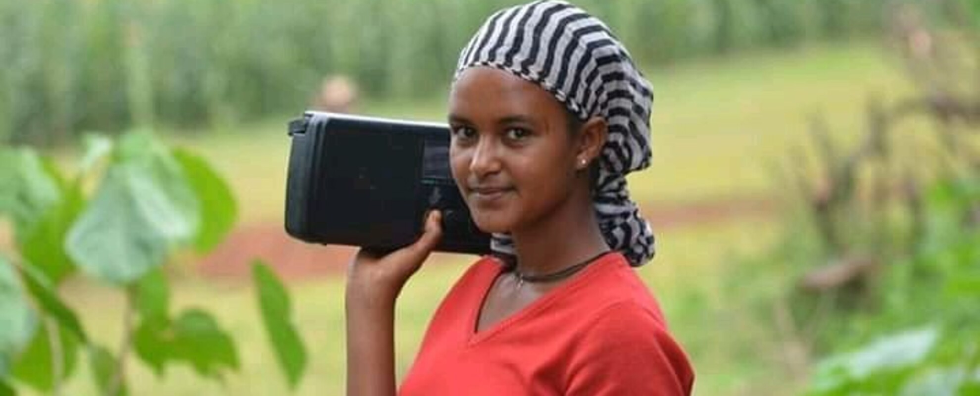 Women farmer in southern part of Ethiopia listening to radio 