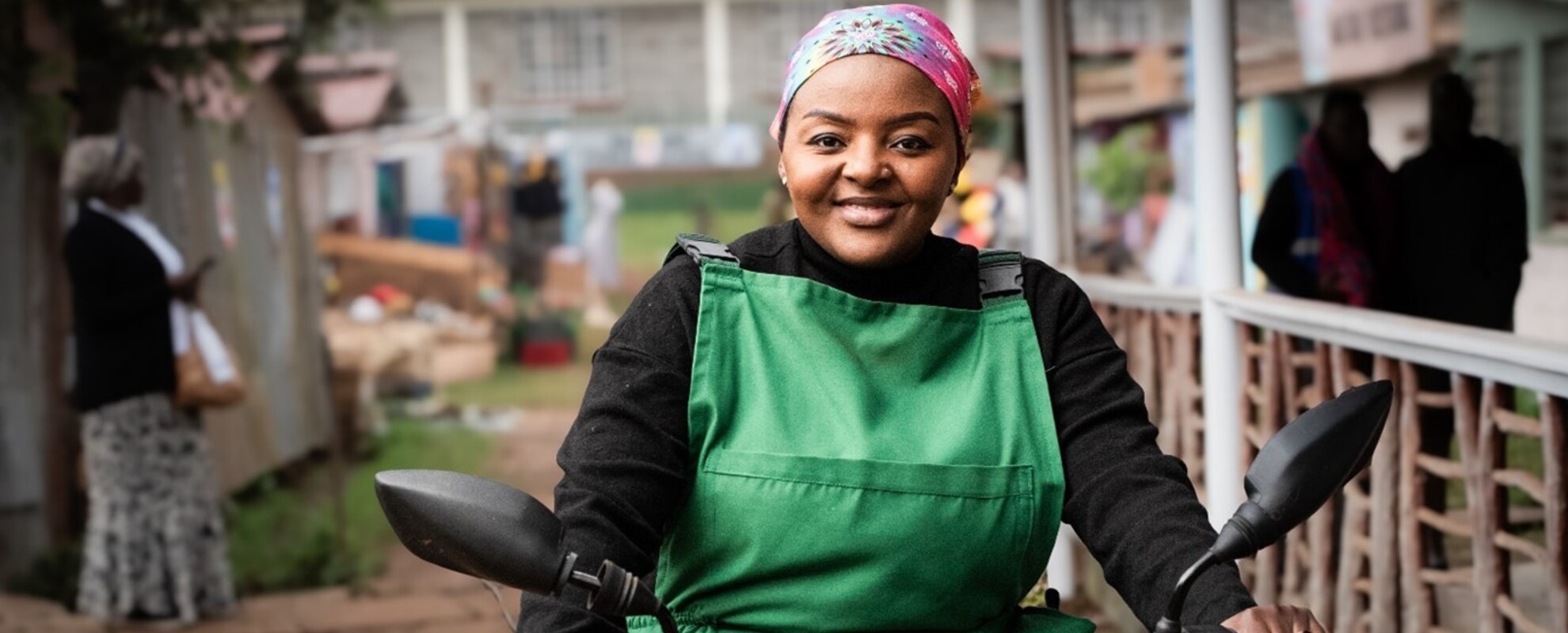 Agripreneur Mwende Baraka, played by Fiona Ashley, defies expectations of women in her community by riding her motorbike through Makutano, delivering veterinary services, vaccinated chicks, and farm inputs to her women clients in the new edutainment series, “Maisha Makutano” (photo credit: Mia Collins).